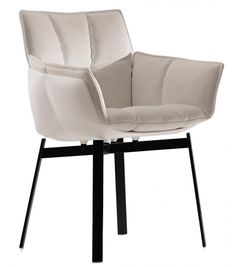 a white chair sitting on top of a black metal frame base with a leather upholstered seat