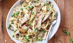 a white plate topped with pasta and chicken