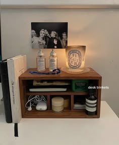 a wooden shelf with various items on top of it and a lamp next to it