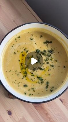 a pot filled with soup sitting on top of a wooden table