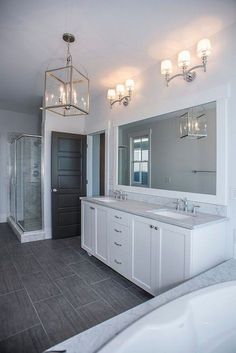 a large bathroom with two sinks and a bathtub