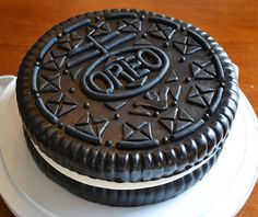 an oreo cookie cake is decorated with black icing