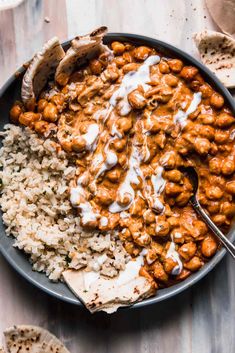 a bowl filled with rice and beans covered in sauce