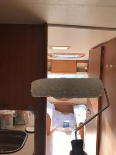 the interior of a camper with wood paneling and white paint on the walls