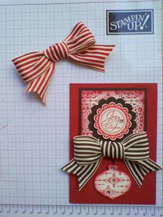 a close up of a greeting card with a bow on the front and an ornament on the back