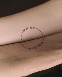 a woman's arm with a circle tattoo on it