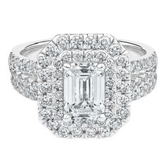 an emerald - cut diamond ring with double halos and pave diamonds on the band