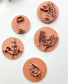 four cookie molds that have been made to look like flowers and birds on them