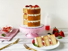 three layer cake with strawberries on the side