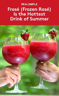 two people holding up wine glasses with strawberries in them and text reading real simple frozen rose is the hotest drink of summer