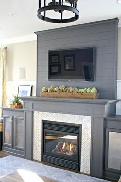 a living room with a fireplace and tv above the mantel in front of it