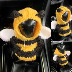 there is a stuffed animal in the car wearing a bee costume on it's head