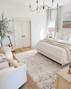 a bedroom with a bed, couch, and guitar in the middle of the room