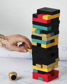 a person is building a tower made out of lego blocks with the words trouva on it