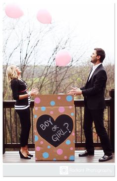 a man and woman standing in front of a cardboard box with a creepy face on it