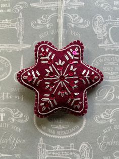 a red and white ornament hanging on a wall