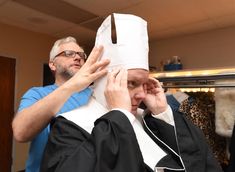 a man getting his hair cut by another person