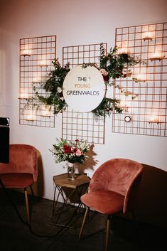 two chairs sitting next to each other in front of a sign that says the greenwalds