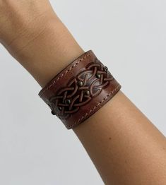 Mens celtic leather bracelet is my author's manual work! Materials: genuine brown leather, metal hardware. Available sizes:  8,86 inches x 1,46 inches; 8,66 inches x 1,46 inches; 8,27 inches x 1,46 inches. My mens and womens handmade leather jewelry may be done to order: celtic cross wrap leather bracelets, minimalist cuff bracelets for men, brooches and necklaces for women. Celtic mens and womens leather jewelry and other goods made by hand are unique gifts for him and for her! They may become Adjustable Viking Leather Bracelet, Adjustable Leather Viking Bracelet, Adjustable Viking Style Leather Bracelet, Adjustable Medieval Leather Bracelet Gift, Medieval Style Adjustable Leather Bracelet For Gift, Medieval Style Adjustable Leather Bracelet Gift, Brown Leather Cuff Jewelry, Bracelets Minimalist, Mens Leather Jewelry