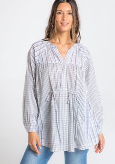 Ultra-relaxed and chic, this cool cotton tunic shirt is designed in a classic mixed plaid print. With voluminous long sleeves, a cinched front waist with ties, and a button front. Try it tied in the front for a loose silhouette, or wrap the ties around your waist for extra definition. FINAL SALE Mixed plaid print Relaxed, oversize fit Voluminous long sleeve Button cuff closure Long tunic length Banded collar Button front Cinched waist detail with ties Slightly sheer Cotton tunic top Model is 5'9 Sheer Embroidered Top, Cotton Tunic Tops, Lace Tunic Tops, Free People Blouse, Plaid Tunic, Cotton Tunic, Oversized Tunic, Lace Tunic, Boho Tunics