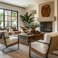 a living room filled with lots of furniture and a fire place in the middle of it