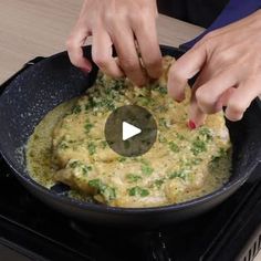 someone is cooking food in a skillet on the stove with their thumb touching it