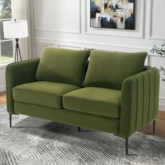 a green couch sitting on top of a rug in a living room