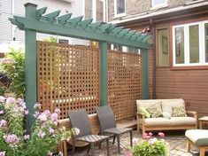 an outdoor living area with furniture and flowers