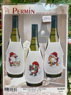 three bottles of wine with santa claus on them