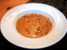 a white bowl filled with sauce on top of a table