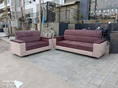 two couches sitting next to each other in front of a building