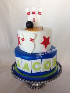 a three tiered cake decorated with bowling pins