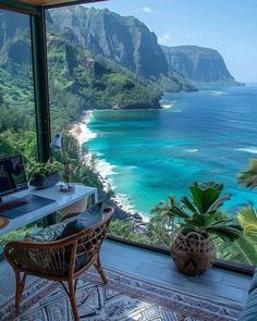 a desk with a laptop on it in front of a large window overlooking the ocean