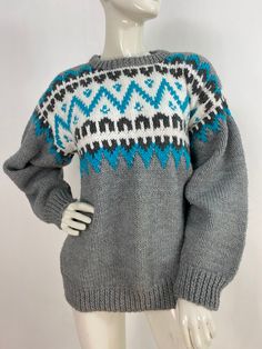 "Vintage hand knit sweater, fair isle sweater, nice colours, white, grey, turquoise, nice quality warm hand knit sweater  Measurements:  Shoulder 17\"-21\"/sleeve 21\"/bust (pit- pit)21\"/bottom width 18\"-26\"/length 26\" Mannequin measurements:  5'8\", bust 34\", waist 25\", hip 33\" Please note that vintage clothing sizes can vary greatly.  The Measurements provided  are approximate and are taken lying flat.  I suggest taking a similar garment from your wardrobe and measure it while lying fla Nordic Style White Sweater With Fair Isle Pattern, White Nordic Sweater With Fair Isle Pattern, White Fair Isle Sweater For Cold Weather, Nordic Knit Patterns For Winter, White Scandinavian Sweater With Fair Isle Pattern, Scandinavian Style White Sweater With Fair Isle Pattern, Blue Fair Isle Sweater For Cold Weather, Nordic Fair Isle Knitting Pattern, Scandinavian Style White Fair Isle Sweater