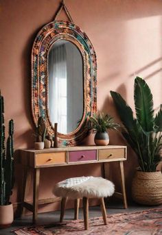 a table with a mirror, stool and potted plants on it in front of a pink wall