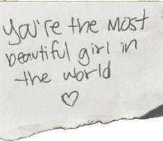 a piece of paper with the words you're the most beautiful girl in the world written on it