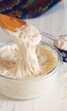 a spoon full of whipped cream in a bowl