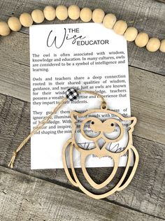 a necklace with an owl cutout on it and a bookmark attached to it