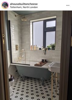 a bath tub sitting next to a window in a bathroom