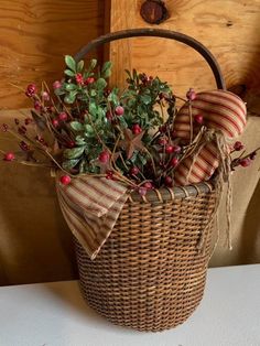 a wicker basket filled with holly and berries