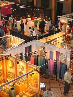 an overhead view of people looking at various items on display in a museum like setting