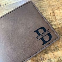 "Our LEATHERETTE Wallet is custom engraved to order. This makes a memorable gift for Teen Son, Grandson, Nephew Gift, Ect. Choose any of our popular designs or send us your own custom wording to be engraved. Comes GIFT BOXED ready to gift! This is a perfect gift for any occasion for the special guy in your life. ♥ ♥ ♥ I T E M . I N F O R M A T I O N ♥ ♥ ♥ ♥ Leatherette vegan Wallet ♥ All Names and Initials will be engraved in the font shown in each design. We can engrave your text, name, dates, Rectangular Wallet With Engraved Logo As Gift, Personalized Classic Leather Wallets, Personalized Rectangular Leather Wallet, Classic Personalized Leather Wallets, Personalized Brown Rectangular Wallet, Customizable Brown Wallets For Personalized Gift, Personalized Leather Wallet Rectangular, Classic Personalized Wallets, Customizable Rectangular Wallet For Personalized Gifts