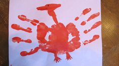 a child's handprint is shown on a piece of paper with red paint