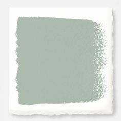 a light green paint swatch on a white background