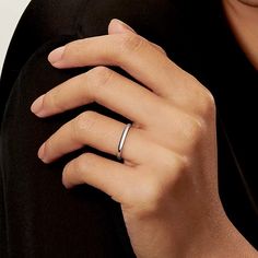 a woman's hand with a ring on her finger