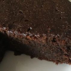 a piece of chocolate cake sitting on top of a white plate