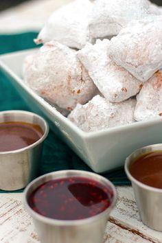 there are several cups and sauces on the table