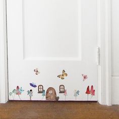 the door is decorated with butterflies and houses