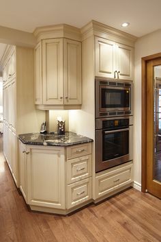 a kitchen with an oven, stove and sink in it's center island area