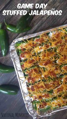 a casserole dish with cheese and green peppers on the side next to it